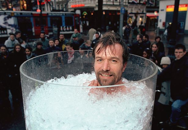 Wim Hof taking an ice bath in front of a crowd of people