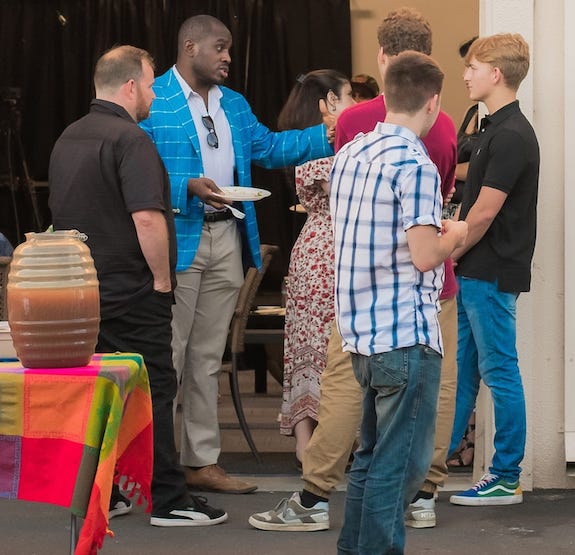 ed latimore surrounded by fellow dudes conversating